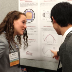 Two people reviewing a research poster