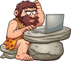 a bearded caveman sits at a computer scratching his head